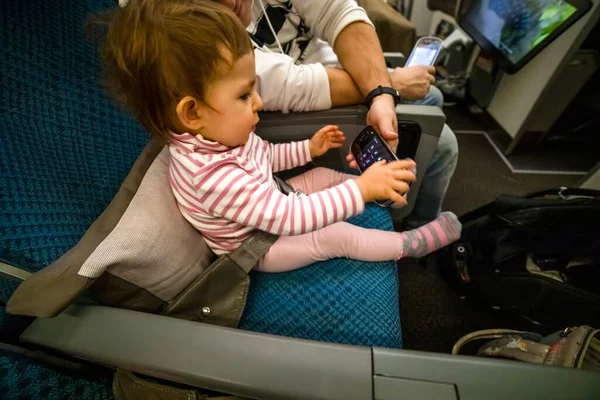 entertainment on board the aircraft in flight. baby sit on the plane in the seat and study the multimedia system remote