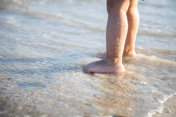 Close-up Babyfüße im Sand und den Wellen des Meeres — Stockfoto
