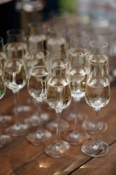 Buffet, glasses of champagne, sparkling wine, sparkling in the sun. Catering, party service. Festive event, welcome drink