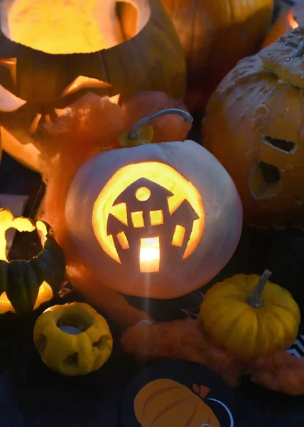 colletion of pumpkins  for halloween with a haunted house cut out vertical for posters and copy space