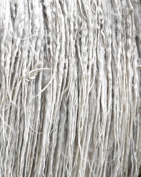 grey alpaca animal fleece un washed and knotty with small pieces of grass, full frame image backgound to ad copy space