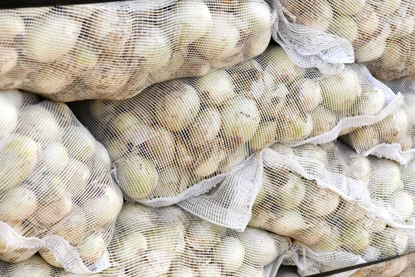 whole mesh sacks of Spanish onions in for british export, selective focus blurred background to ad copy space