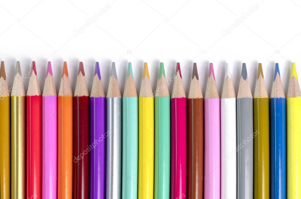a row of vibrant coloured pencils with clean tips  on a white background for copy space or text overlay 