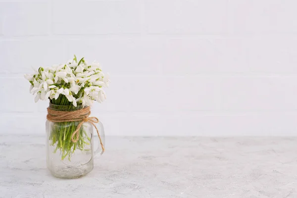 Bouquet Spring Flowers Snowdrops Glass Vase Light Brick Wall Copy — Stock Photo, Image