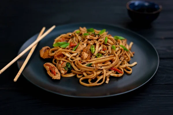 Asian Udon Noodles Chicken Vegetables Teriyaki Sauce Chopsticks Black Wooden — Stock Photo, Image