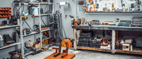 Workshop with workbench, shelving, tool kit, lift