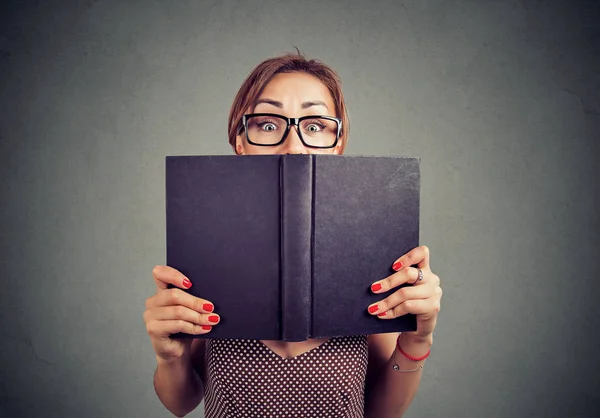 Close Portrait Shocked Young Girl Hiding Open Book Isolated Gray — Stock Photo, Image