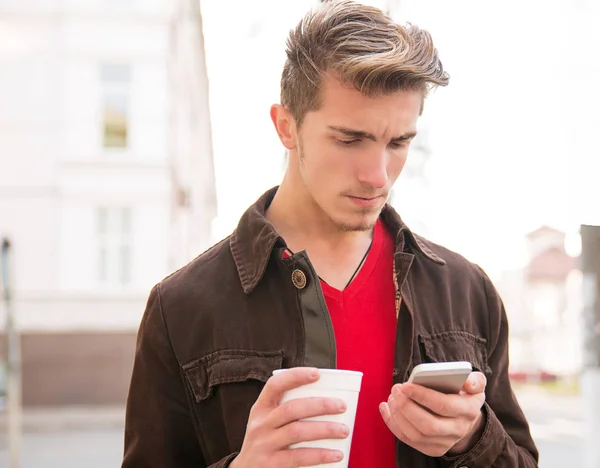 Young Man Having Coffee Cup Looking Serious While Surfing Smartphone — Stock Photo, Image