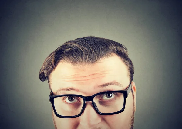 Крупный План Толстого Человека Очках Смотрящего Вверх Задающего Вопросы Сером — стоковое фото