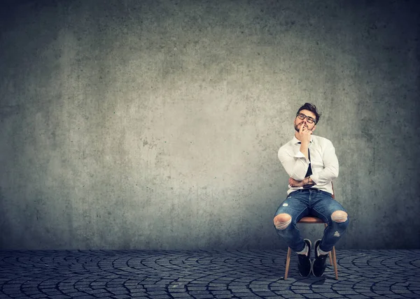 Young Casual Man Sitting Chair Touching Lips While Looking Thinking — Stock Photo, Image