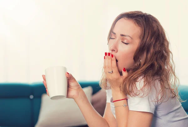 Portrait Young Woman Sitting Sofa Cup Coffee Yawning — Stock Photo, Image