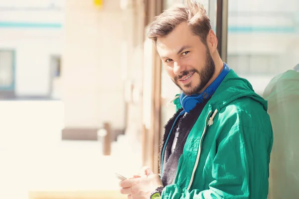 Young Bearded Man Blue Headphones Using Smartphone Street Looking Camera — Stock Photo, Image