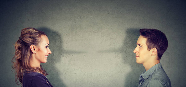 Side view of liar man and woman cheating to each other having problems in marriage. 