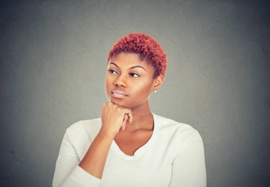 Woman thinking. Portrait of a serious beautiful young woman looking away clipart