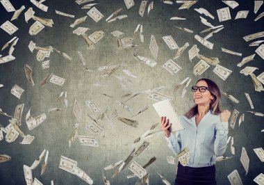 Doları para çevrimiçi iş kurma tablet bilgisayar kullanan başarılı genç kadın aşağı düşen nakit faturaları. Acemi bu girişimci başarı ekonomi kavramı