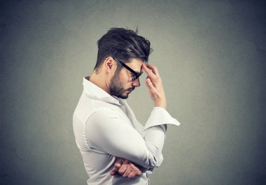 Depresyon ve düşünceler dolu alnı olmak dokunmadan gözlük ve beyaz gömlekli sakallı adam yan görünüm