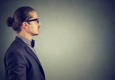 Takım elbise gri arka plan üzerinde ciddi seyir yetişkin modern insan yan görünüm