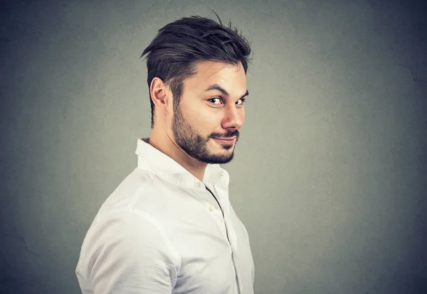 Young Dishonest Man White Shirt Looking Pretend Smile Camera Gray — Stock Photo, Image