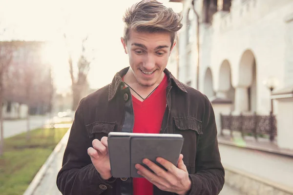 Cheerful Casual Man Jacket Standing Outdoors Surfing Tablet Happily — Stock Photo, Image