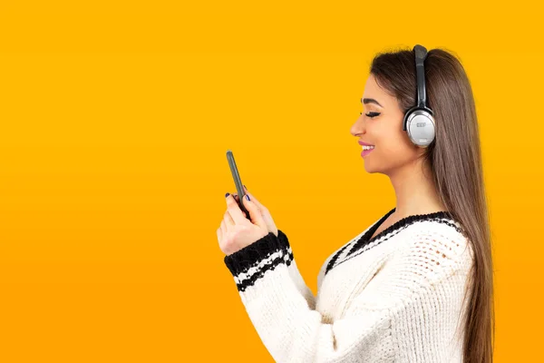 Женщина слушает музыку с наушниками на мобильном телефоне — стоковое фото