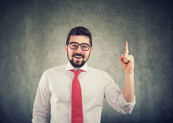 Empresario con gafas con una buena idea apuntando con el dedo hacia arriba y sonriendo — Foto de Stock