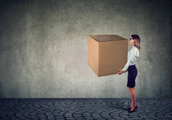 Mulher de negócios carregando uma enorme caixa — Fotografia de Stock