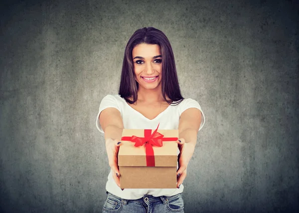 Портрет милой улыбающейся девушки, дарящей подарочную коробку — стоковое фото