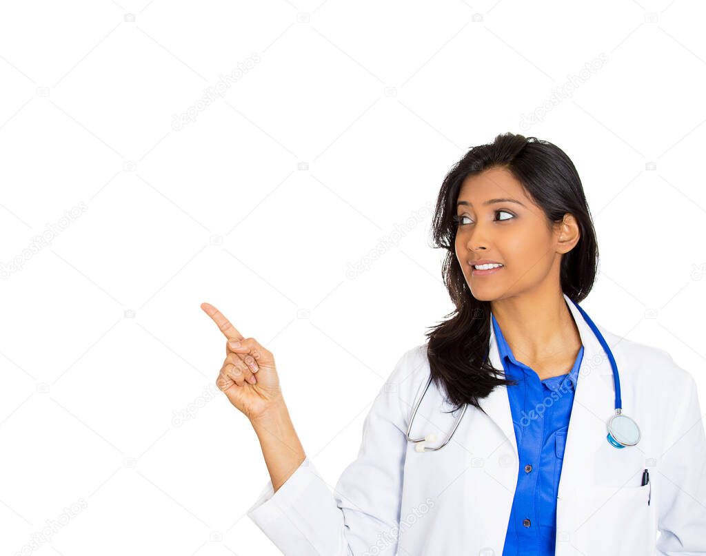 Portrait of a friendly smiling confident female, healthcare professional with lab coat, a doctor pointing at blank copy space 