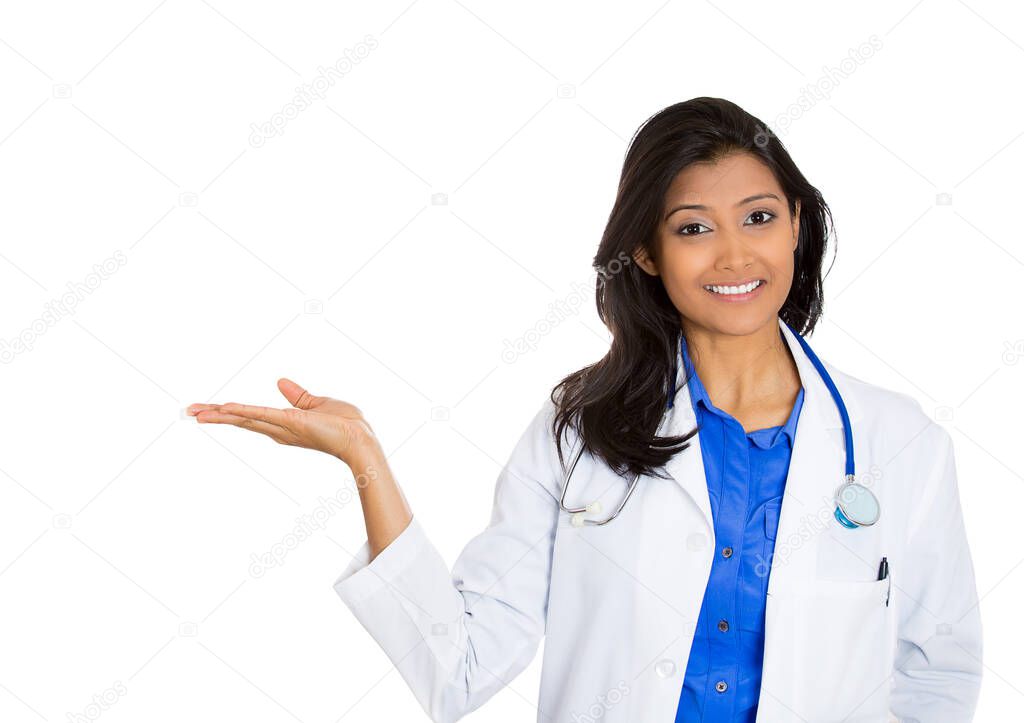 Portrait of a friendly smiling confident female, healthcare professional with lab coat, a doctor pointing at blank copy space 