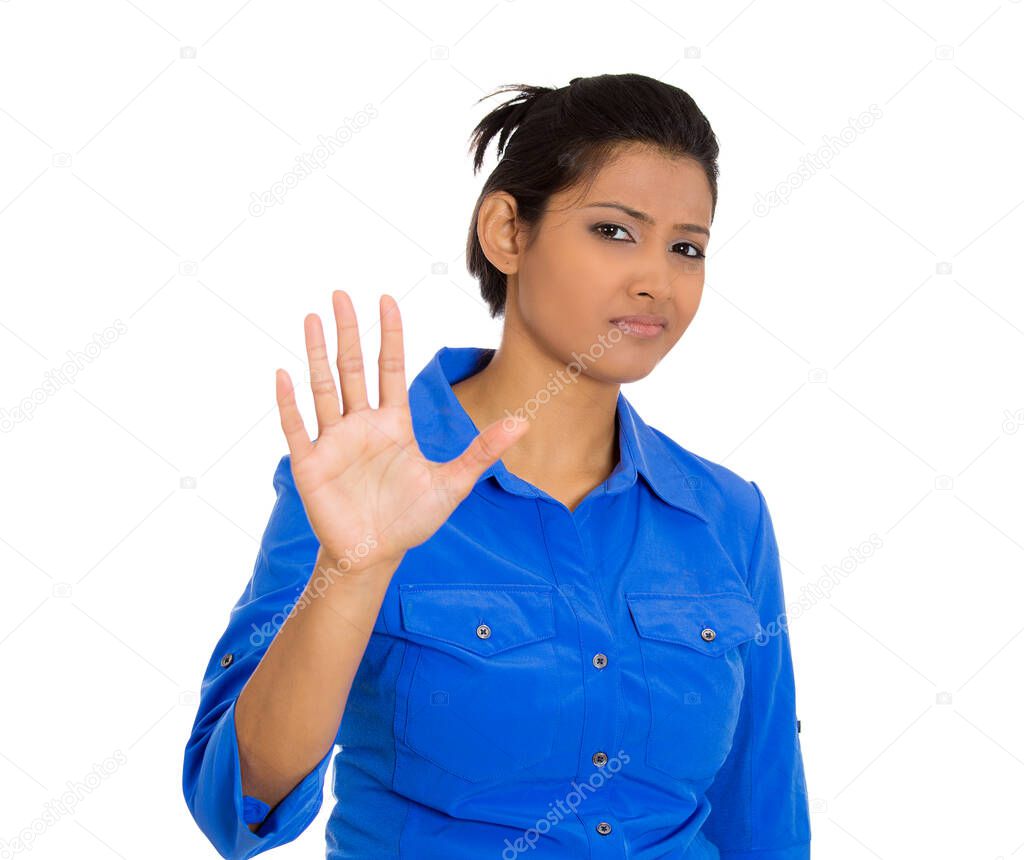 Portrait of a furious mad angry annoyed young woman raising hands gesturing to stop isolated on white background 