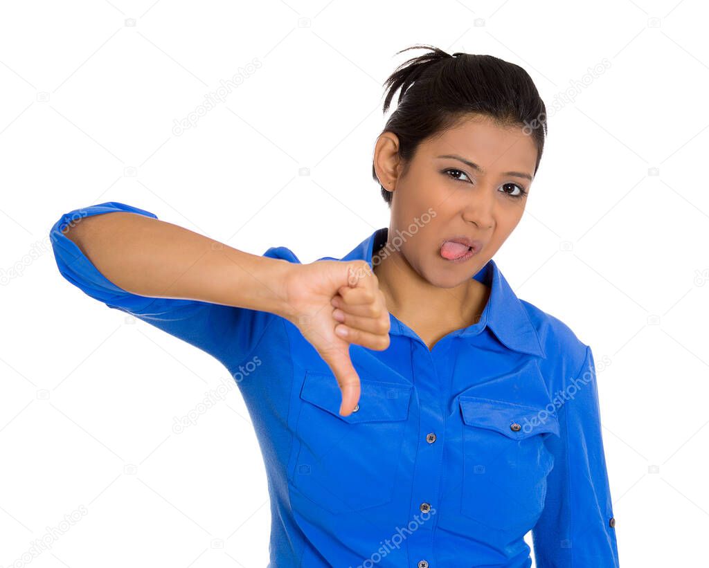 Portrait of an unhappy angry woman feeling annoyed, giving thumbs down gesture looking with negative facial expression 