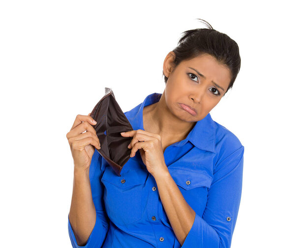 Closeup portrait of an upset, sad, unhappy woman standing showing empty wallet, isolated against white background