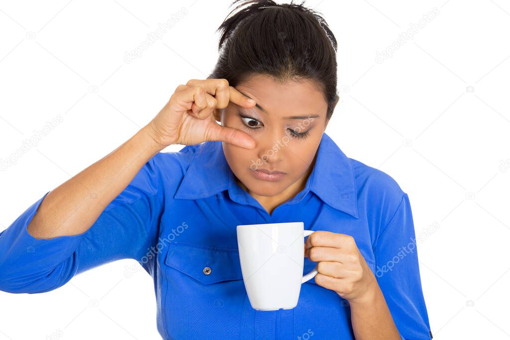 Portrait of a very tired sleepy young woman holding cup of coffee struggling not to crash stay awake, keeping eyes opened