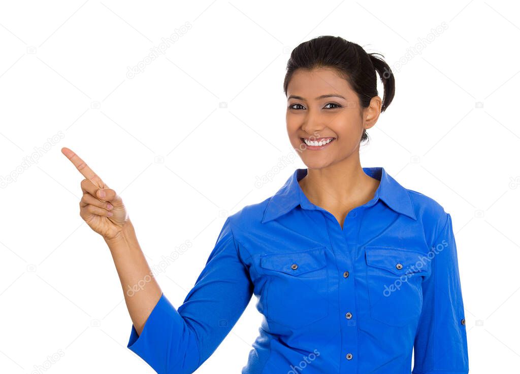 Portrait of happy young smiling woman gesturing pointing to space at left isolated on white background.