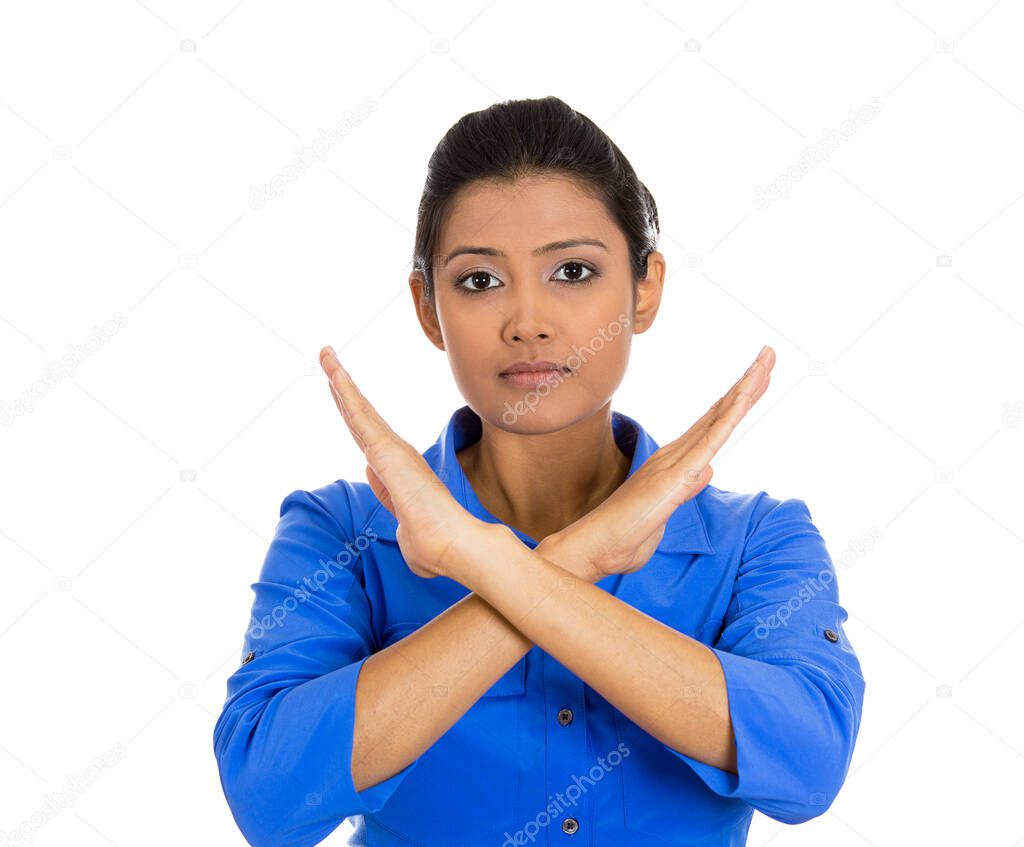 Portrait of an angry young woman with X gesture to stop talking isolated on white background. Negative emotion facial expression feelings, signs symbols
