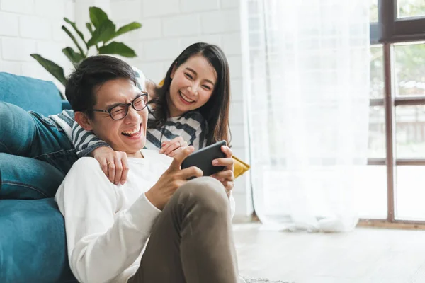 Asian couple man and woman talking working  spend time together at home, Asian couple family lifestyle concept