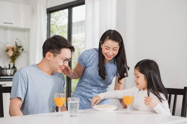アジアの家族の幸せキッチンでテーブルの上で朝食を楽しむ — ストック写真