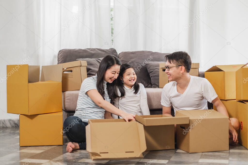Asian family moving to new home/house and unpacking boxes