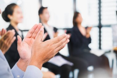 Young business people clapping hands during meeting in office for their success in business work clipart