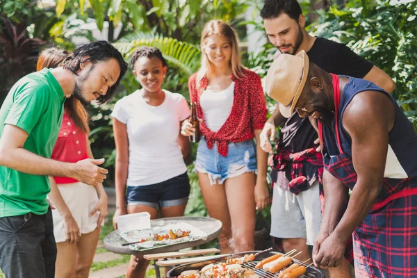 Group of diversity people having barbecue/barbeque party at home, cooking grilled meat/beef for lunch, happy friends party lifestyle concept