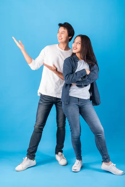 Genç Asyalı Mutlu Çift Kadın Avuçlarını Açık Tutarak Mavi Arka — Stok fotoğraf