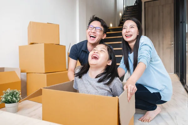 Asian family moving to new home / apartment with many packing boxes