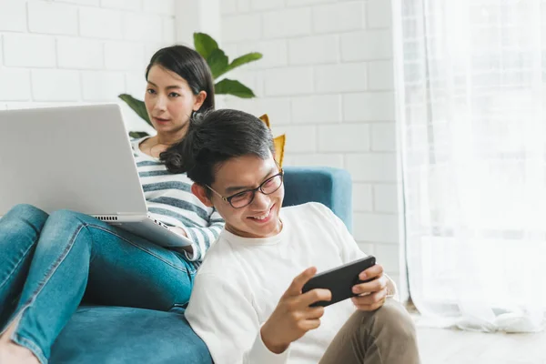 Asian couple man and woman talking working  spend time together at home, Asian couple family lifestyle concept