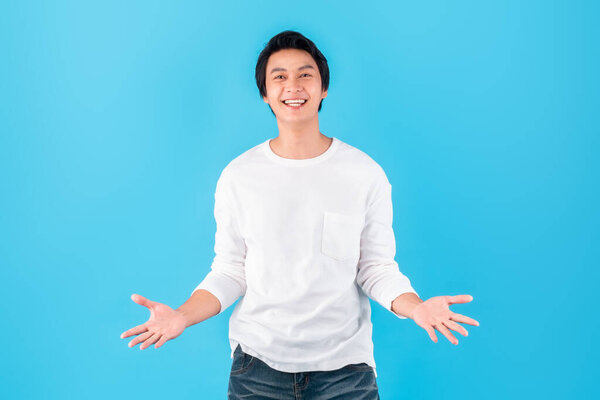 Young happy Asian man open palm hand feel surprise / shock / amazed / wow over blue background