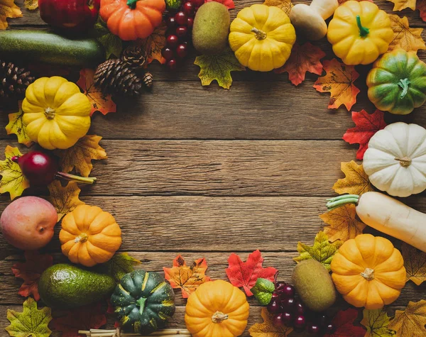 Thanksgiving background, pumpkin, leaves and decoration on wood table background with copy space. flatlay