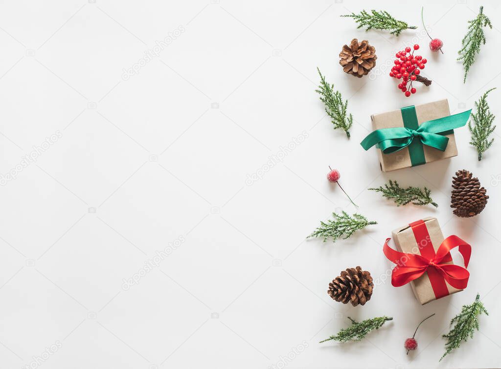 Christmas background, frame with fir branches tree pinecone gift and present over white background. flatlay copy space