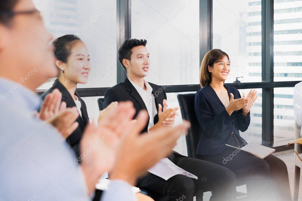 Young business people clapping hands during meeting in office for their success in business work