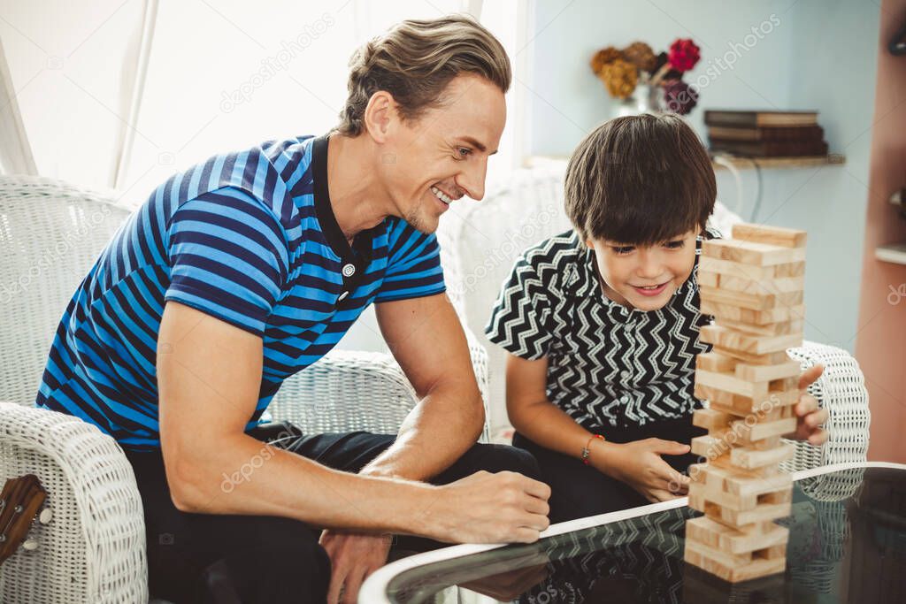 Happy family, father playing wooden blocks with son, cute boy, happy and smile