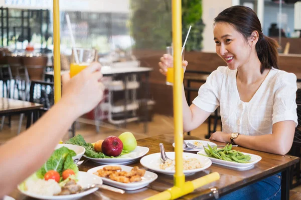 Asiatisk Kvinde Sidder Adskilt Restaurant Spiser Mad Med Bord Skjold - Stock-foto