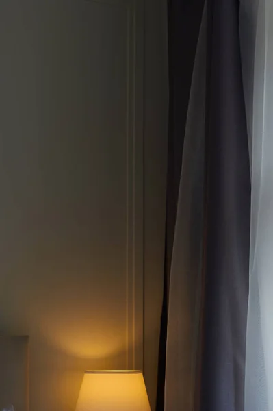 Curtains in a hotel with part of the lamp and the fluorescent light minimalism